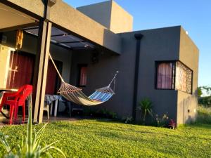 a hammock hanging from the side of a house at Funes Inn in Funes