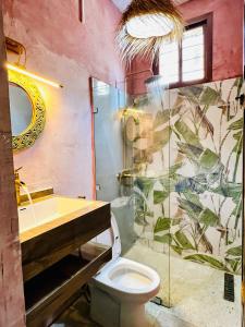 a bathroom with a toilet and a shower and a sink at Nuru House Stone Town Ensuite 3BR Apartment in Zanzibar City +54 photos