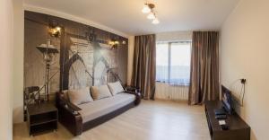 a living room with a couch and a table at Apartments Chudo in Estosadok