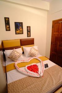 a bedroom with a bed with a cake on it at Aruppukottai Nadar Lodge in Chennai