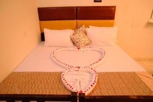 a heart decoration on top of a bed at Aruppukottai Nadar Lodge in Chennai +3 photos