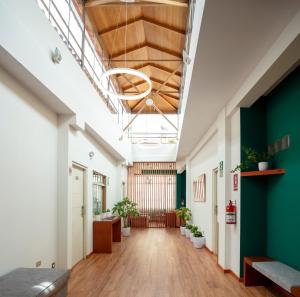 an office corridor with green and white walls at Maytaq Wasin Boutique Hotel in Cusco +43 photos