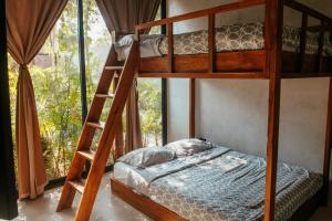 a bedroom with two bunk beds and a window at Villa Camila Tulum in Tulum +10 photos