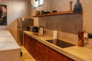 a kitchen with a sink and a refrigerator at Villa Camila Tulum in Tulum