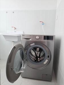 a washing machine in a bathroom with a sink at Cusco Nest in Cusco