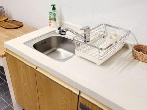 a kitchen sink with a dish drying rack next to it at SiSu2 in Chilgok