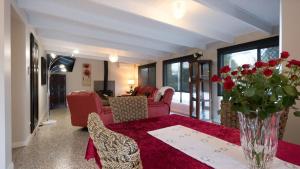 a living room with a table with a vase of flowers at Ruthmor Villas in Toowoomba