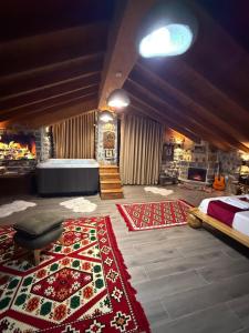 a bedroom with a bed and rugs on the floor at Bujtina Kael in Librazhd