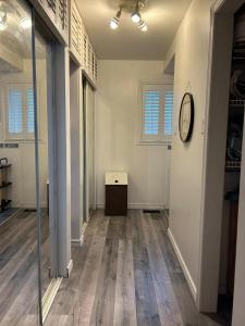 an empty room with a clock on a wall at Chalet Style, Lakeview Cottage in Bailieboro +24 photos