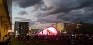 a crowd of people in a city at night at Modern Townhome Near Downtown walk to CWS! in Omaha