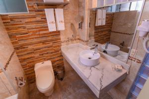 a bathroom with a sink and a toilet and a mirror at Sol Plaza Hotel in Puno