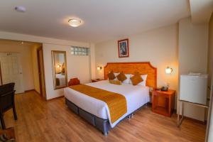 a bedroom with a large bed in a hotel room at Sol Plaza Hotel in Puno