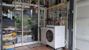 a laundry room with a washing machine in it at ichi in Ōkasho