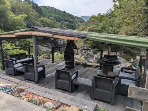 a gazebo with chairs and a grill on a deck at ichi in Ōkasho