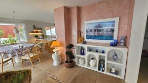 a living room with a toy kitchen with a table at Bajo el Sol in Nelson +14 photos