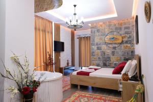 a bedroom with a bed and a bath tub and a room at Bujtina Kael in Librazhd
