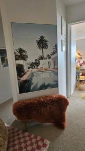 a mirror in a living room with a picture of a pool at Bajo el Sol in Nelson