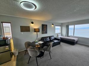 a living room with a couch and a table at Tui Oaks Motel in Taupo