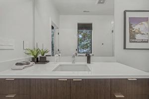 a white bathroom with a sink and a window at Baernhaus in Government Camp +48 photos