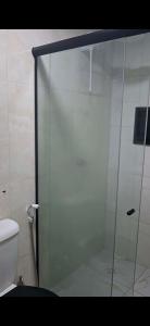 a glass shower in a bathroom with a toilet at Pousada Brasil Tropical in Bezerros