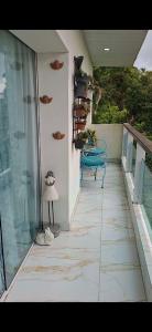 a balcony with a table and a bench on a building at Pousada Brasil Tropical in Bezerros