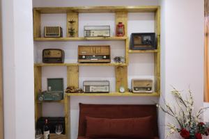 a shelf filled with appliances on a wall at Bujtina Kael in Librazhd +28 photos