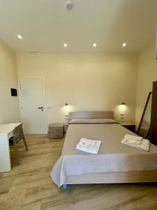 a bedroom with a bed and a desk and a door at B&b Al Centro Nicosia in Nicosia +13 photos