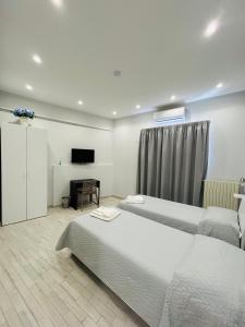 a hotel room with two beds and a television at B&b Al Centro Nicosia in Nicosia