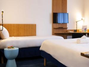 a hotel room with two beds and a tv at ibis Styles Nancy Centre Gare in Nancy +109 photos