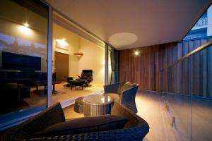 a living room with two chairs and a table at Four Seasons Yuzawa Quattro in Yuzawa