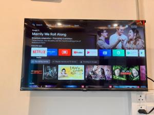a tablet screen on a wall with several different videos at RADHA Homestay in Mathura