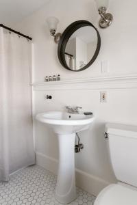 a white bathroom with a sink and a mirror at The Lindsey Hotel in Rockland +18 photos