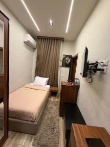 a hotel room with two beds and a flat screen tv at Italia Hotel Cairo in Cairo