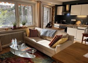 a living room with a couch and a table at Garden apartment in Ettlingen
