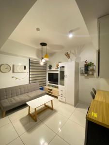 a living room with a couch and a table at Carlota247 in Cebu City +8 photos