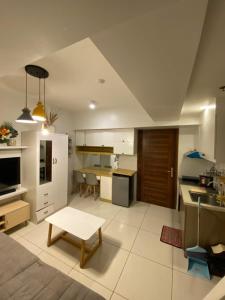 a living room with a kitchen and a table in it at Carlota247 in Cebu City