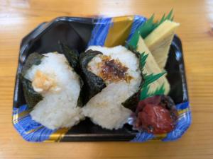 a plate of sushi with rice and vegetables on a table at ichi in Ōkasho