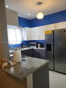 a kitchen with a refrigerator and a counter top at Beit Elohim in Lucea