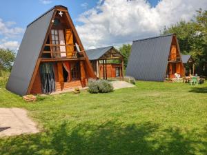 a home with two story houses on a grass field at Cabañas Don Luis in Valle Hermoso +18 photos