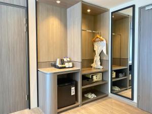 a walk in closet with a counter and a mirror at Swiss-Belexpress Jemursari in Surabaya +23 photos