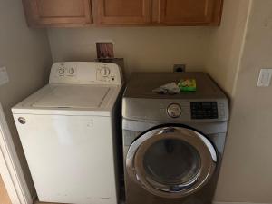 a small kitchen with a washing machine and a washer at Goodyear Cul-de-sac Room 6 in Goodyear +3 photos