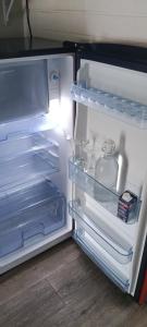 an open refrigerator with its door open and itsartmentsearchacersacersacersacersacers at Memphis Motor Inn- UNDER NEW MANAGEMENT in Parkes