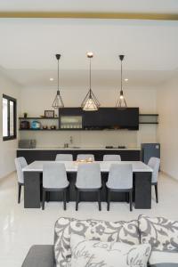 a dining room with a table and chairs at Moment Villa in Lembang