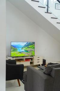 a living room with a flat screen tv on a table at Moment Villa in Lembang
