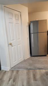 a white door and a refrigerator in a room at Guest suite with great comfort in Brampton