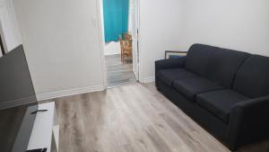 a living room with a couch and a flat screen tv at Guest suite with great comfort in Brampton