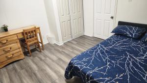 a bedroom with a bed and a desk and a desk at Guest suite with great comfort in Brampton