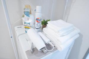 a shelf with towels and cleaning products in a refrigerator at Park building Tenmonkan 1 in Kagoshima +21 photos