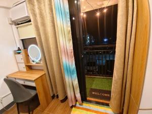 a room with a window and a chair and a mirror at Balay Madayaw in Davao City