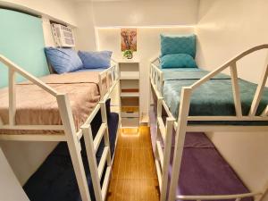 a small room with two bunk beds in it at Balay Madayaw in Davao City